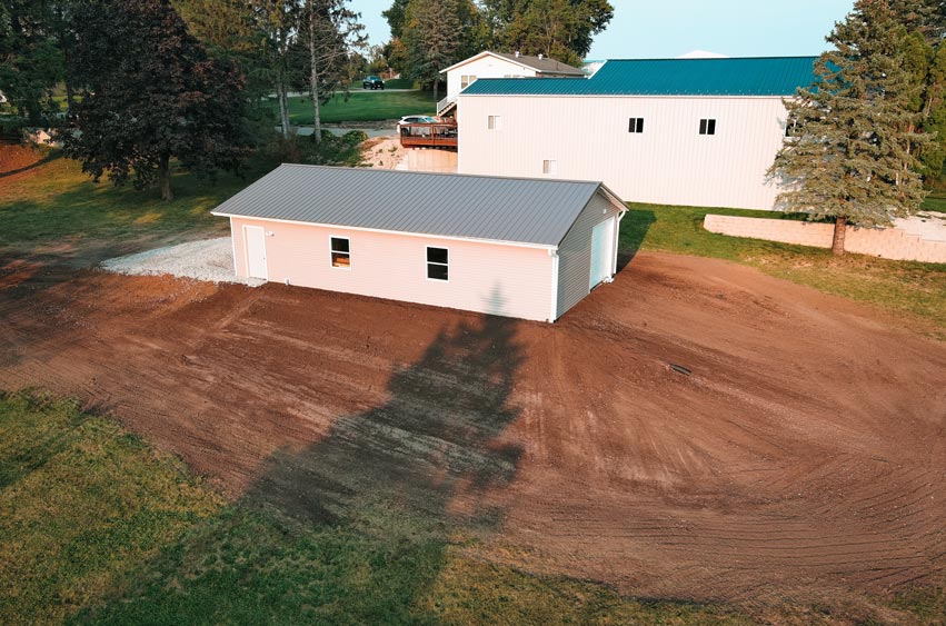 Graded and leveled site around a newly constructed building in Eastern Iowa.